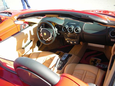 1998 Ford Crown Victoria - Interior of a Ferrari F430 convertible showing tan leather seats, F430 dash badge and yellow prancing-horse logos.