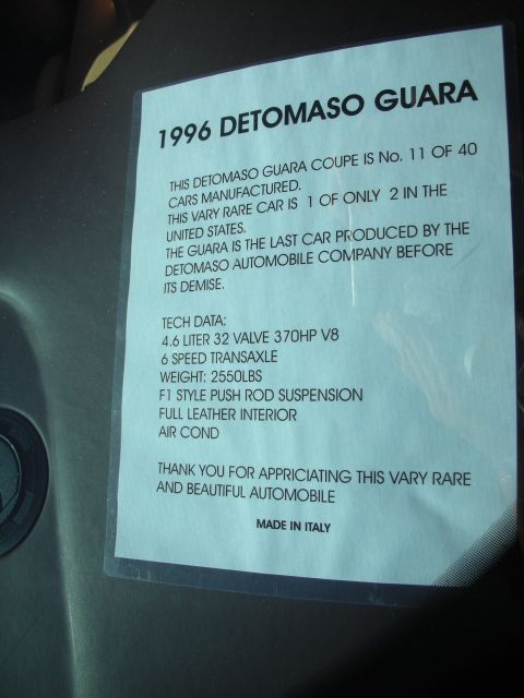 1998 Ford Crown Victoria - Car show display card describing a rare 1996 DeTomaso Guara with its technical specifications.