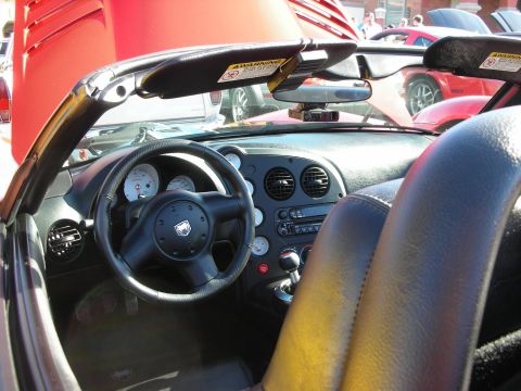 1998 Ford Crown Victoria - Interior of a black convertible sports car showing a Viper-badged steering wheel, twin gauges, and center console.