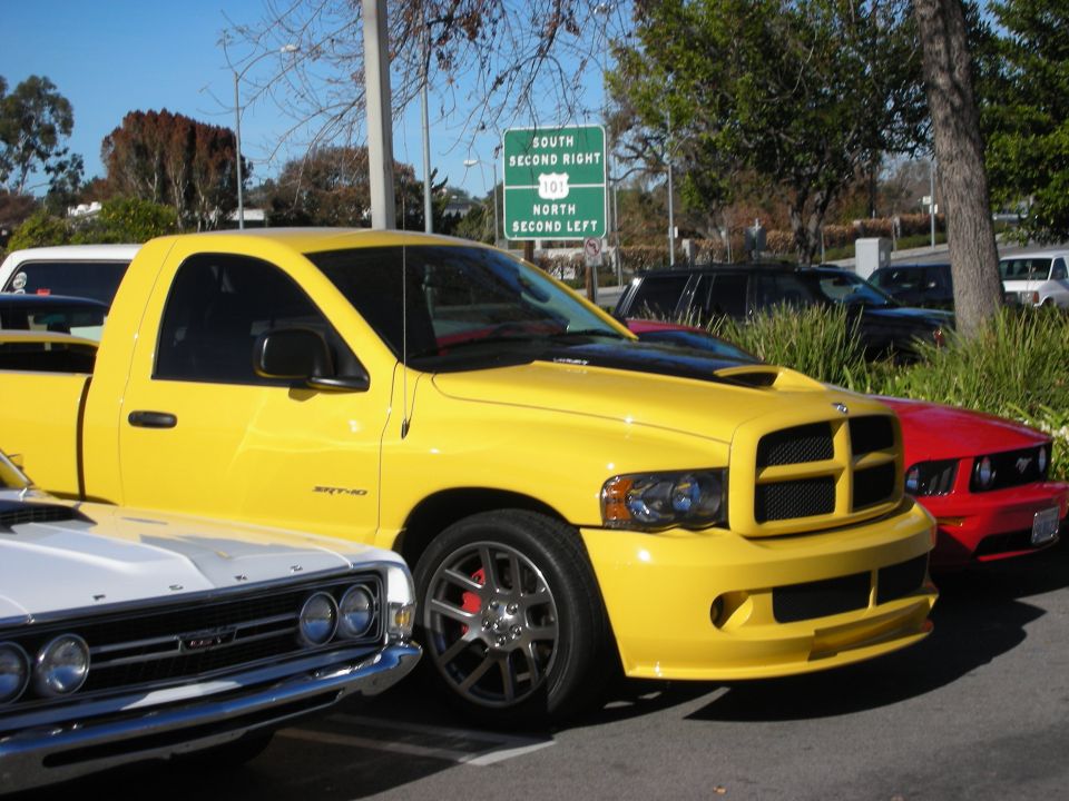 Yellow Dodge Ram SRT-10 pickup parked among cars at an outdoor lot