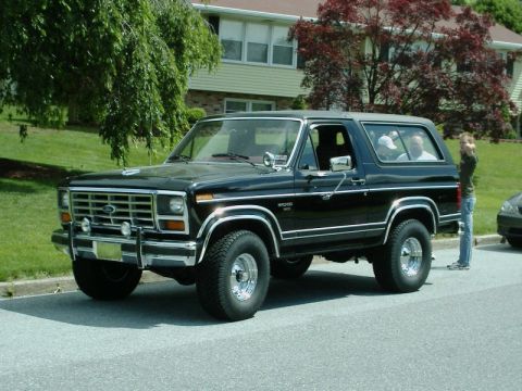 1984 Ford Bronco - A black Ford Bronco from the early 1980s is seen from a three-quarter front view.
