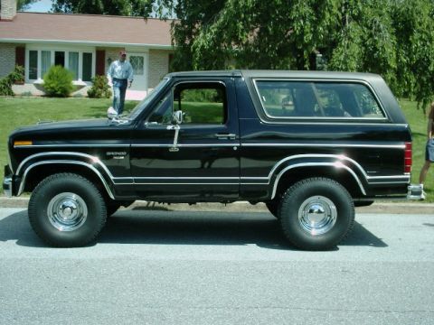 1984 Ford Bronco - A black 1984 Ford Bronco is parked on a residential street.