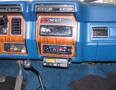 1984 Ford Bronco - The dashboard features wood grain accents and an XLT trim badge, along with multiple audio components.