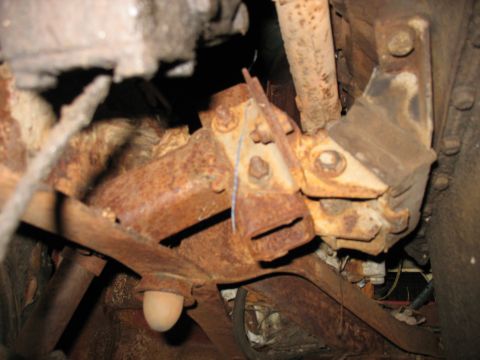 1952 Ford Pickup - Close-up view of heavily rusted engine mount and suspension components, likely from an older vehicle.