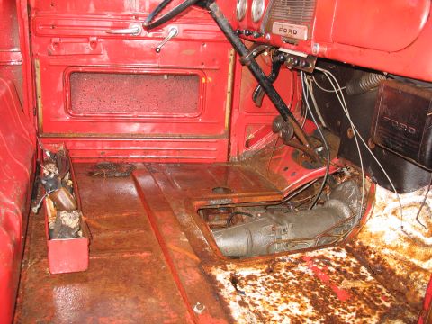 1952 Ford Pickup - The interior of this vintage Ford pickup shows significant rust on the floor and transmission tunnel.