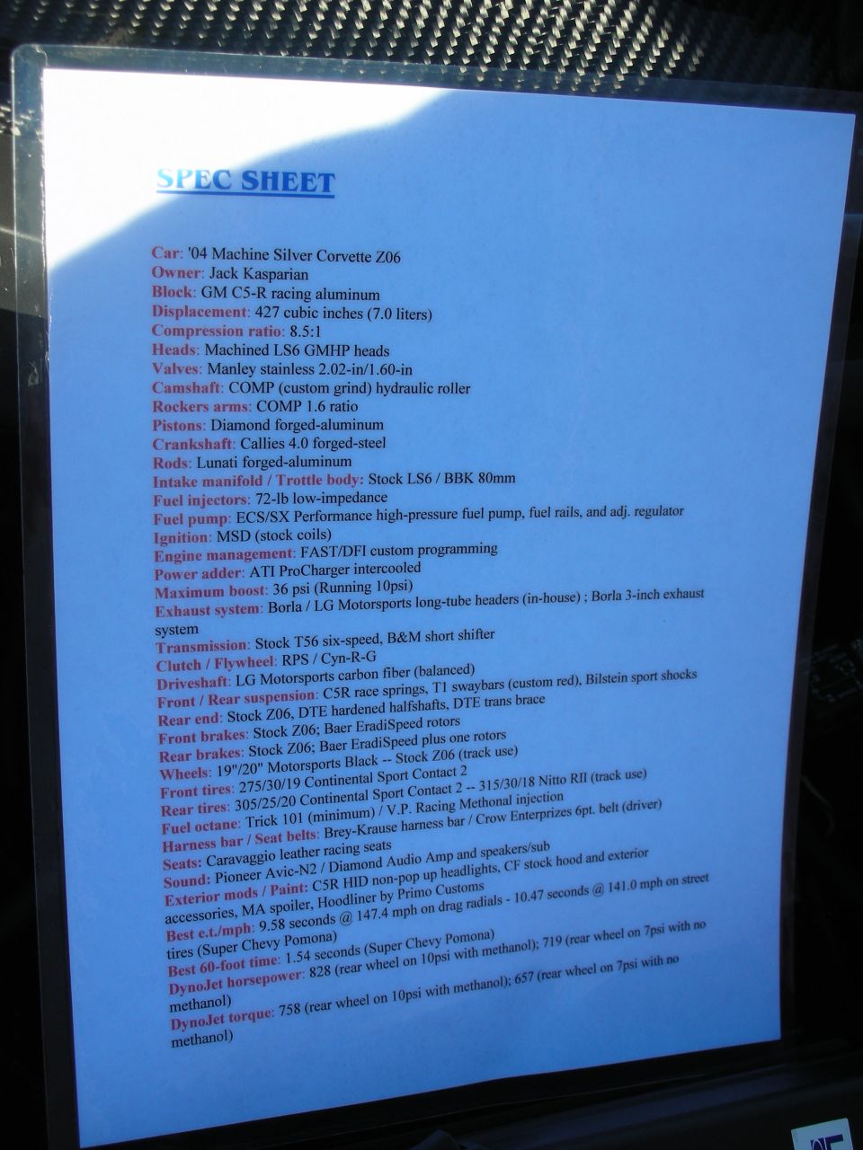 Typed 'SPEC SHEET' display card listing engine, drivetrain and performance specs for a 2004 Corvette Z06