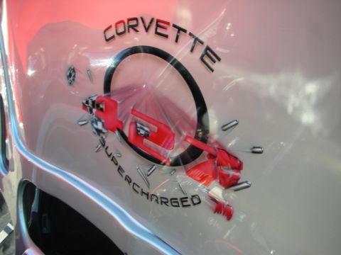 1998 Ford Crown Victoria - Airbrushed body graphic reading CORVETTE SUPERCHARGED with a stylized supercharger illustration on a silver panel.