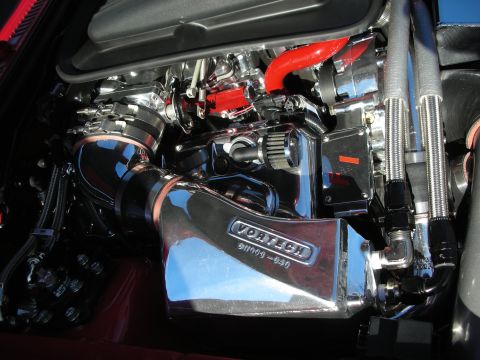 1998 Ford Crown Victoria - heavily chromed engine bay dominated by a Vortech supercharger with polished intake tubing and red silicone hoses.