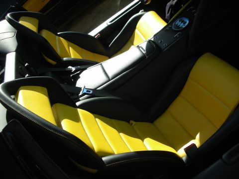 1998 Ford Crown Victoria - Two-tone black and yellow leather sport seats with center console buttons inside a sports car cabin.
