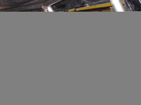 1977 Ford F-150 - Close-up view of the truck bed, showing yellow and black accents. This is a 1977 Ford F-150.