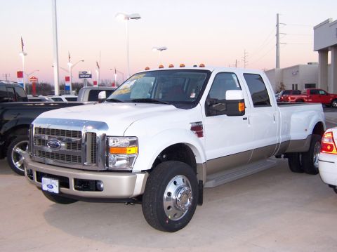 2000 Ford Excursion - This white Ford Super Duty dually truck has a chrome grille and tan lower body panels.