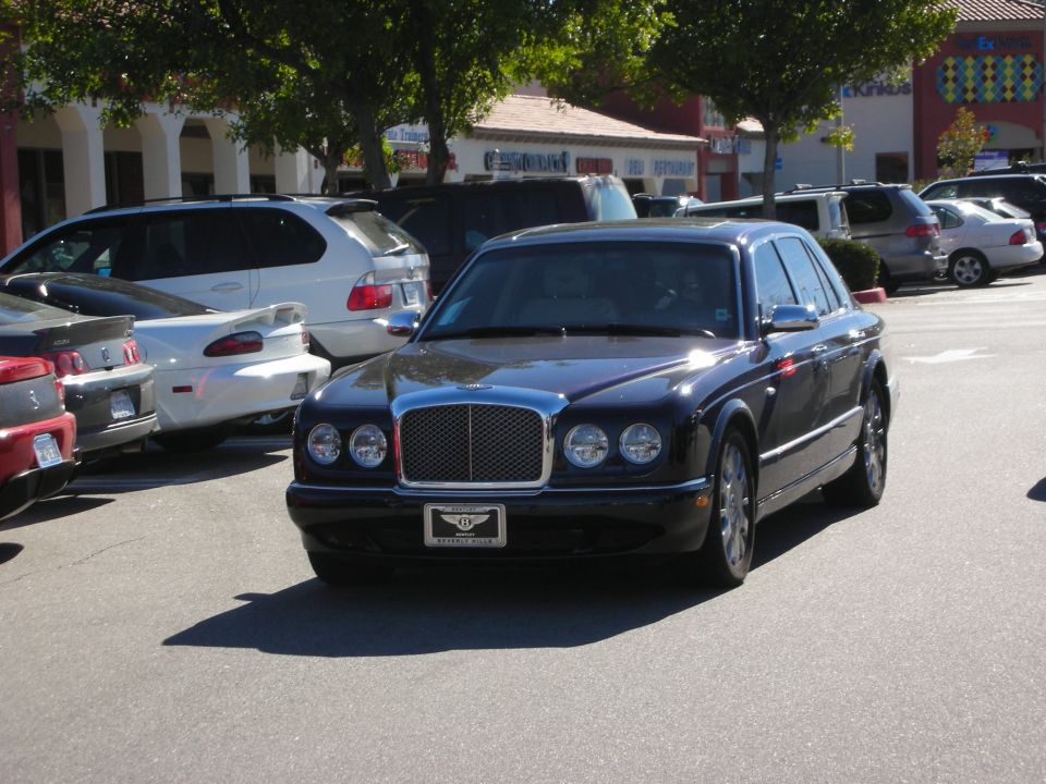 Black Bentley Arnage luxury sedan parked in a shopping center lot