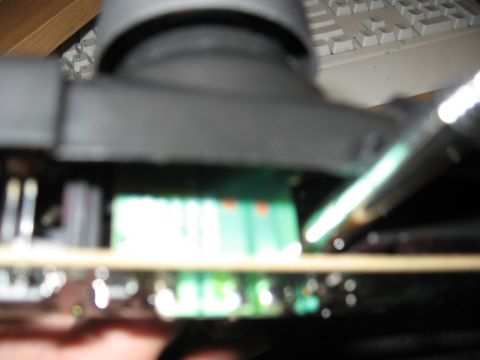 1990 Ford Bronco - A close-up view of electronic components and connectors on a circuit board, with a keyboard visible in the background.