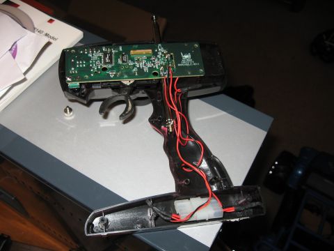 1990 Ford Bronco - A disassembled remote control transmitter shows its internal electronic components and wiring.