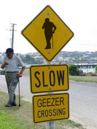 1968 Ford Mustang - A humorous 'Geezer Crossing' sign is displayed, accompanied by an elderly gentleman leaning on his cane.