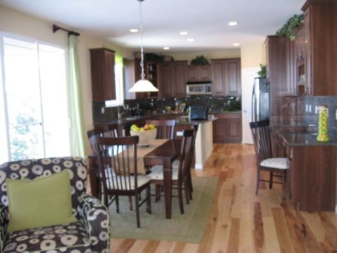 1995 Ford Bronco - Interior view of a home's kitchen and dining space, dark wood cabinetry and a central dining table.