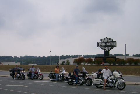 2005 BMW R1200CA ABS - Several motorcycles are parked in front of a Harley-Davidson dealership.