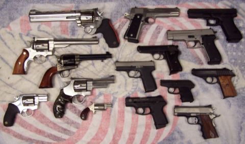 1990 Ford Bronco - A collection of handguns including revolvers and semi-automatic pistols.