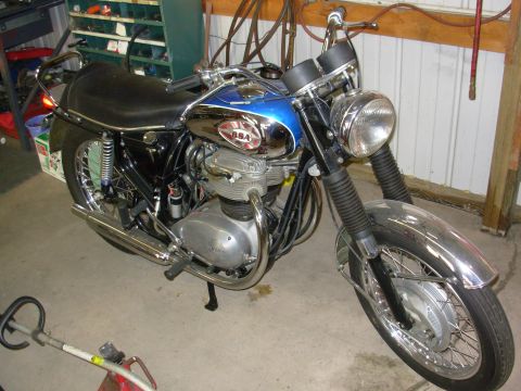 1968 BSA Lightning - A blue and chrome BSA motorcycle is parked indoors, showing its engine and front wheel.