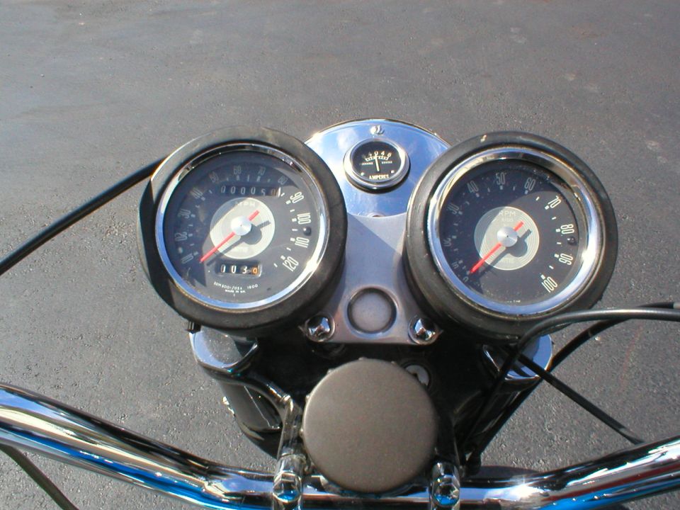 Motorcycle speedometer and tachometer gauges with central ammeter above chrome handlebars