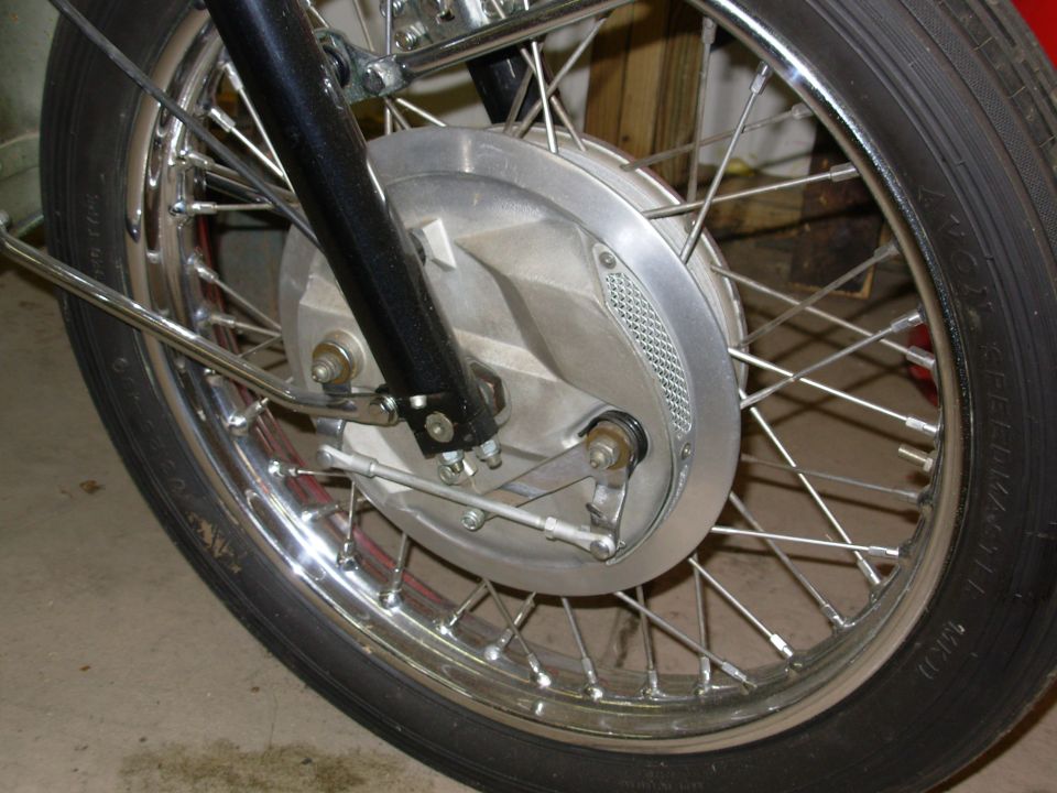 Motorcycle front spoked wheel with chrome rim and aluminum drum brake hub
