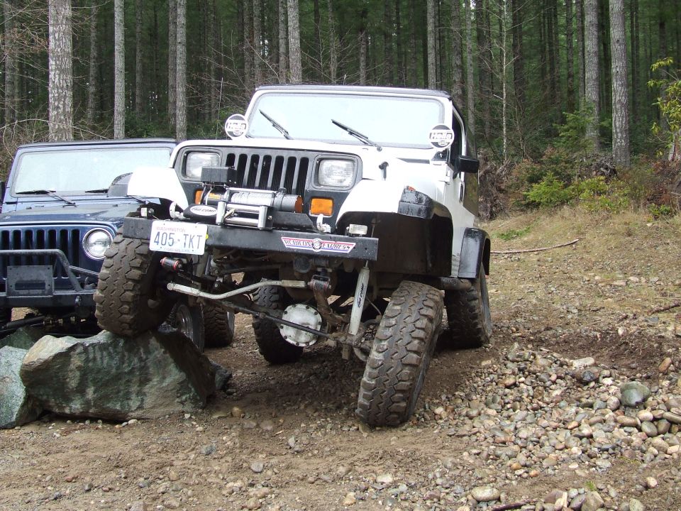 1991 Jeep Wrangler on rocks with another Jeep behind it