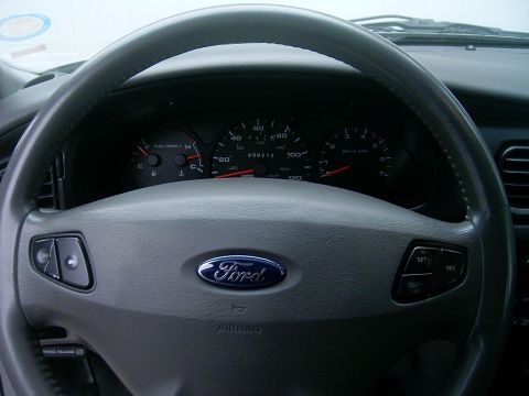 2002 Ford Taurus - Dashboard view of a 2002 Ford Taurus, highlighting the steering wheel and instrument cluster.