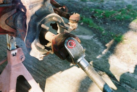 1978 Ford Bronco - Close-up of a Dana 60 front axle U-joint, likely undergoing maintenance or repair.