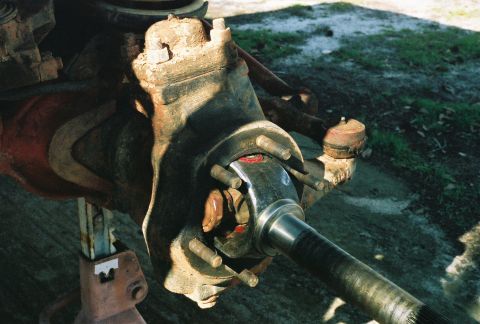 1978 Ford Bronco - Close-up of a Dana 60 front axle hub and spindle assembly, likely undergoing maintenance.