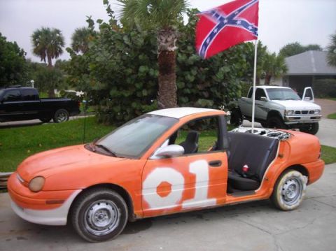 1974 Ford F-100 - Modified Dodge Neon with a Confederate flag and two pickup trucks in the background.
