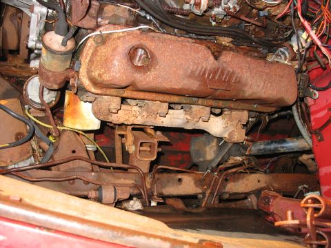1952 Ford Pickup - Close-up view of heavily rusted engine and chassis components, likely from an older vehicle.