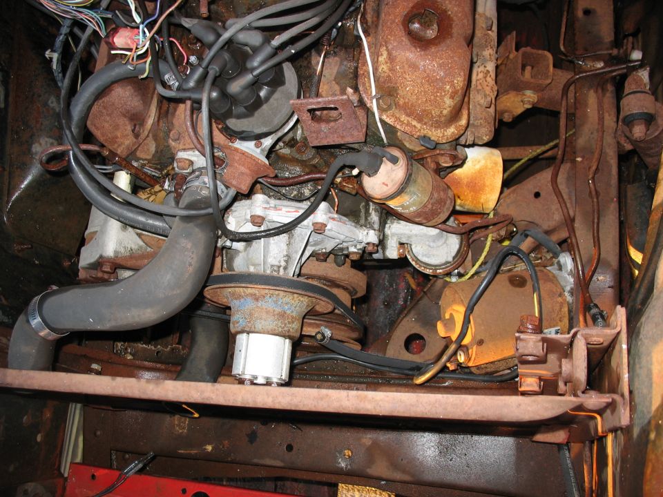 engine bay with rusty parts and wires