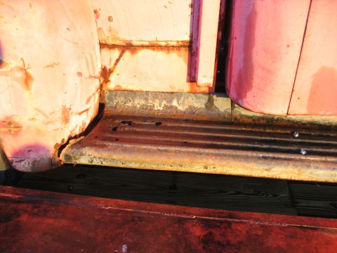 1952 Ford Pickup - Close-up of the rusted step and door edge on a 1952 Ford Pickup.