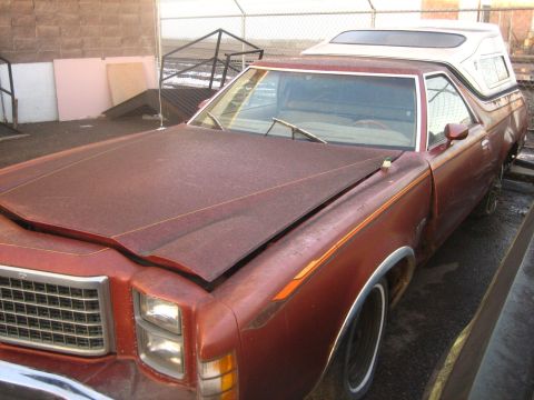 1979 Ford Ranchero - This 1979 Ford Ranchero, seen from the front three-quarter angle, is a maroon pickup truck with a white camper shell.