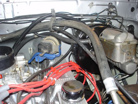1979 Ford Bronco - Engine bay components including carburetor, spark plug wires, and brake fluid reservoir are visible in this close-up shot.