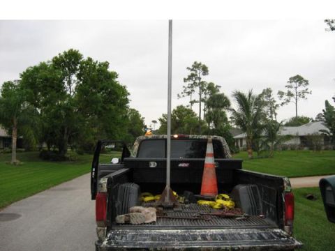 1974 Ford F-100 - Rear view of a pickup truck bed filled with tools and safety equipment on a cloudy day.