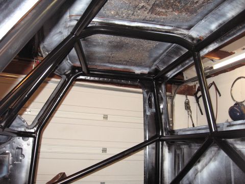 1977 Ford F-150 - Roll cage installation in progress inside a vehicle's interior.