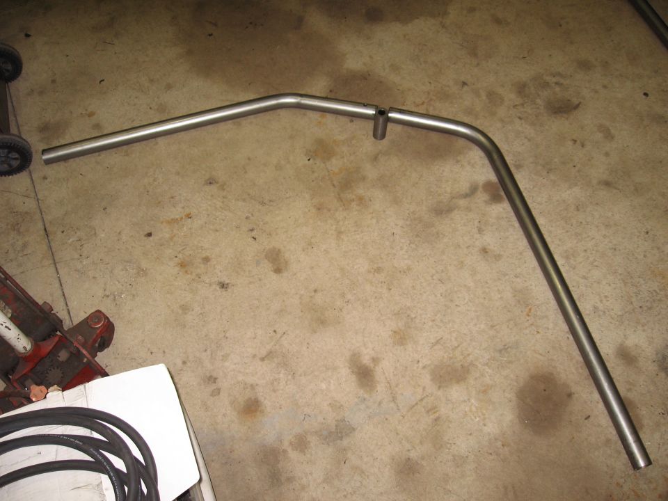 Metal exhaust pipe bent into a U-shape with a small vertical pipe attached