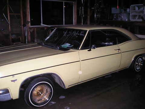 1986 Ford Bronco II - This 1965 Chevrolet Impala coupe is parked indoors and has a "FOR SALE" sign on the windshield.