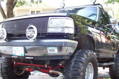 1991 Ford Bronco - Front view of a black Ford Bronco, a prominent grille and auxiliary lights.