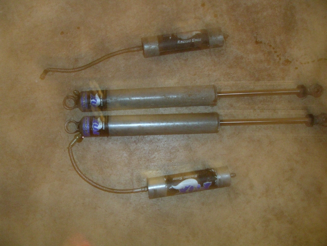 Four shock absorbers with labels showing a horse and text that reads 'Racing Shock'