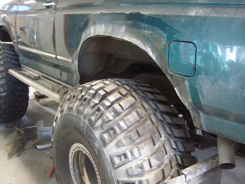 1996 Ford Bronco - Close-up of a 1996 Ford Bronco's rear fender and massive off-road tire.