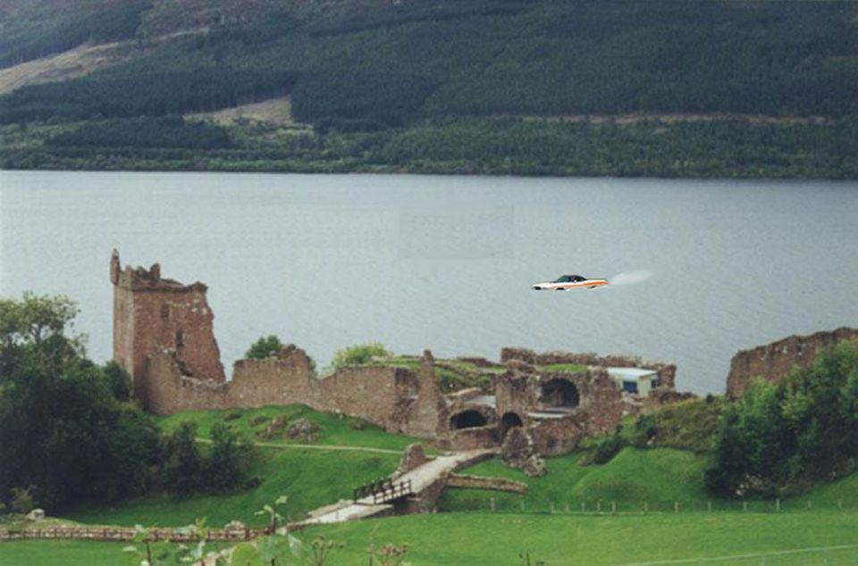 White and orange 1971 Ford Ranchero flying over Loch Ness near Urquhart Castle