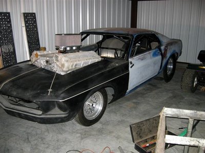 1974 Ford F-100 - This custom drag car features a massive dual engine setup and a roll cage, appearing to be in a workshop.