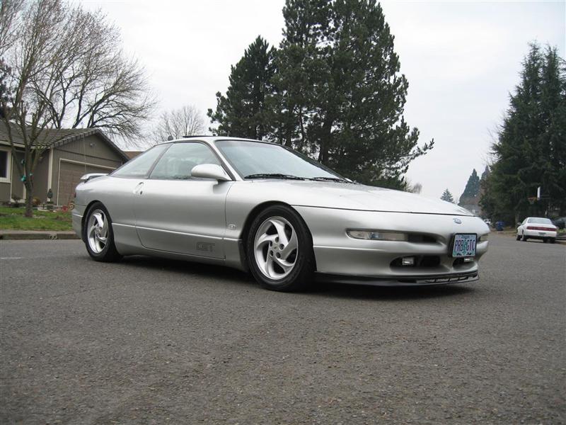 Silver 1994 Ford Probe GT parked on a residential street, with another car in the background