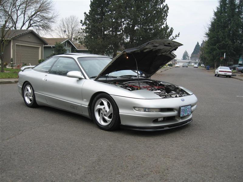 Silver 1994 Ford Probe coupe with hood open, parked on a residential street