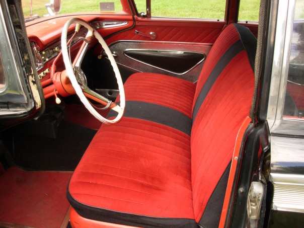 1959 Ford Fairlane interior showing red and black striped seats and white steering wheel