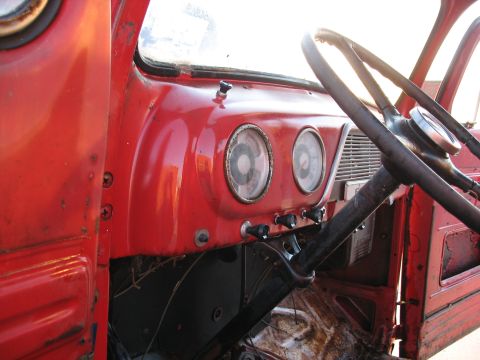 1952 Ford Pickup - Interior view of a vintage truck's dashboard, showing gauges and steering wheel.