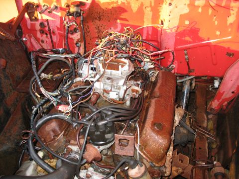 1952 Ford Pickup - Engine bay with a carburetor and distributor, heavily rusted and covered in tangled wires.