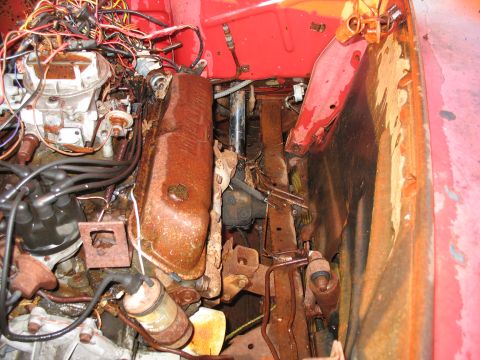 1952 Ford Pickup - The engine bay is heavily rusted and filled with a complex network of wires.